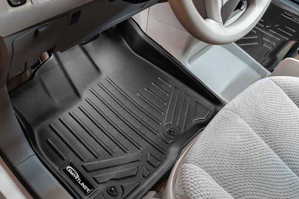 SMARTLINER custom fit floor liner in a Toyota Sienna, front driver-side footwell, black all-weather mat with raised edges and deep channels