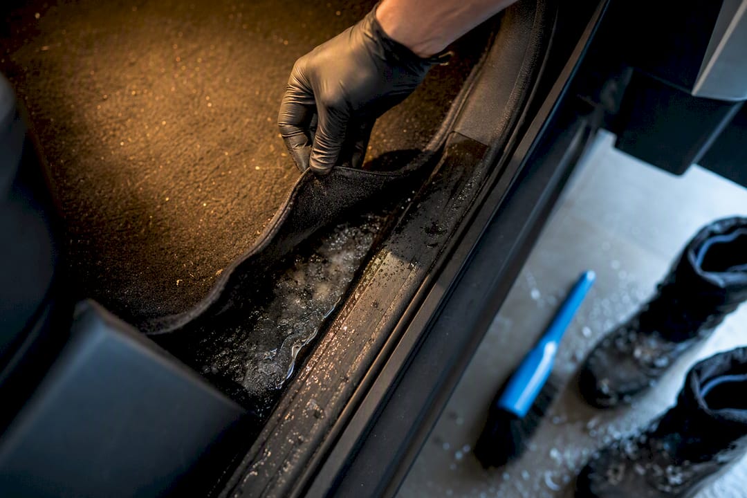 Road salt beside an anonymous vehicle footwell