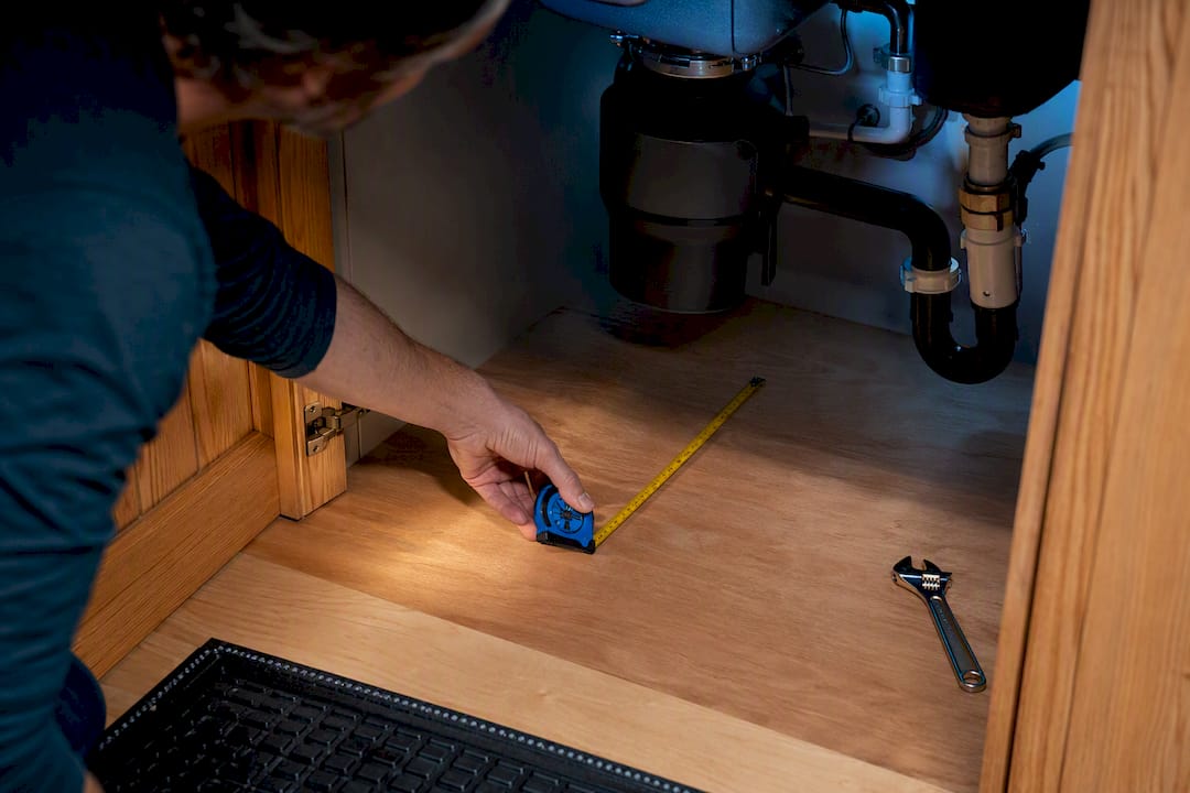 Measuring cabinet clearance beneath garbage disposal