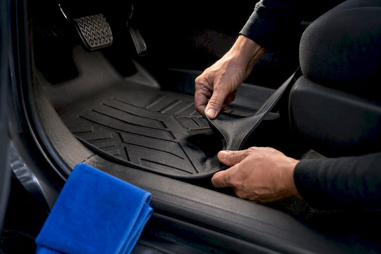 Hands testing car mat retention